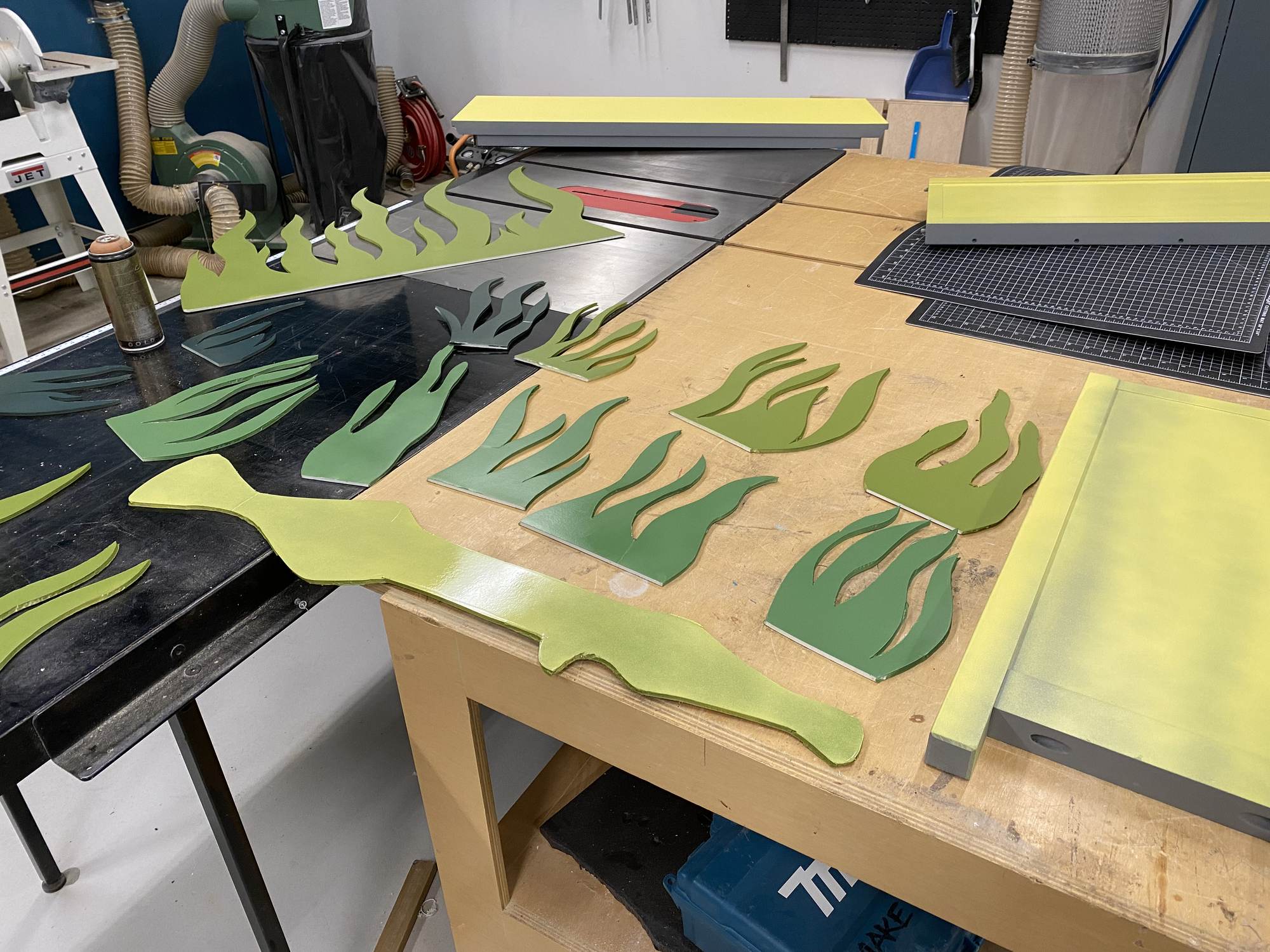 Volunteers cutting and painting pieces