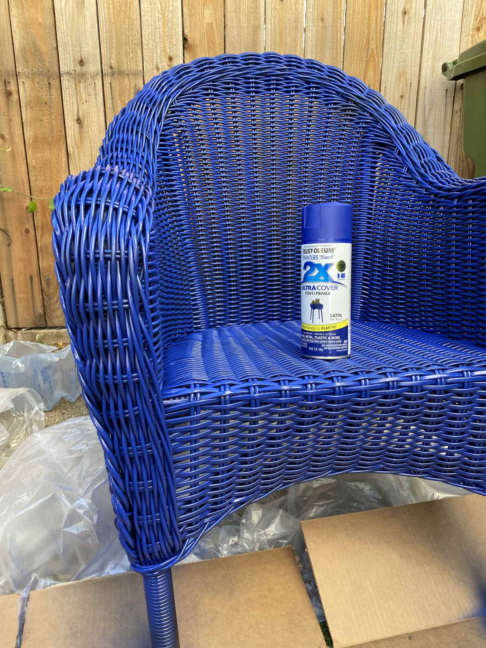 Spray-painting a wicker chair blue